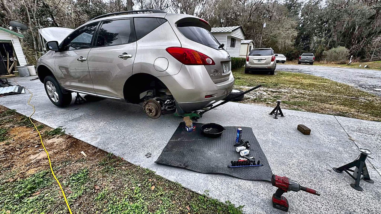 C&C performing a full rear brake job on an SUV in a customer's Ocala driveway